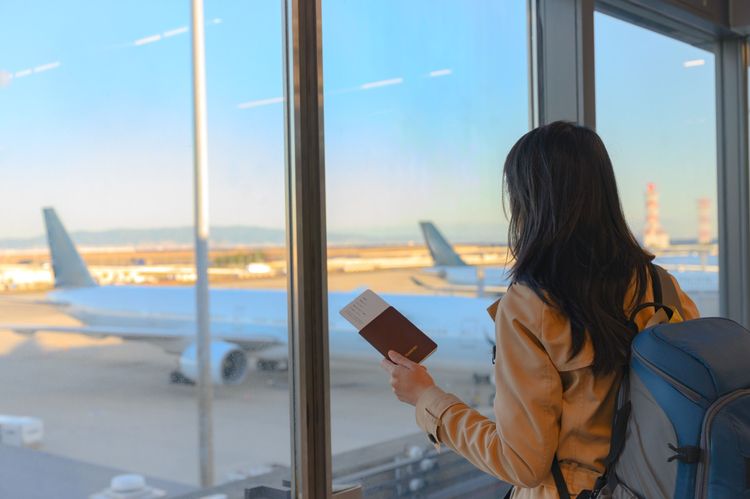 Voyageuse prête à embarquer avec son passeport et sa carte d'embarquement