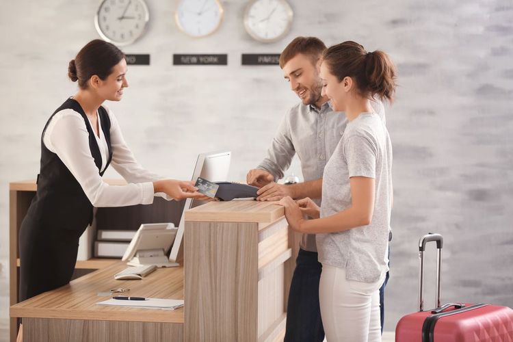 Des clients à la réception d'un hôtel