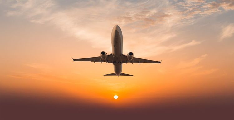 Un avión despega al atardecer