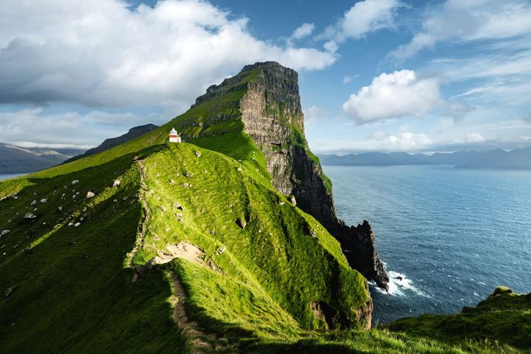 Le phare de Kallur sur les collines verdoyantes de l'île de Kalsoy